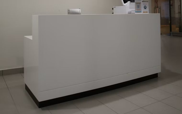 Completed reception desk built to a standardized multi-site specification