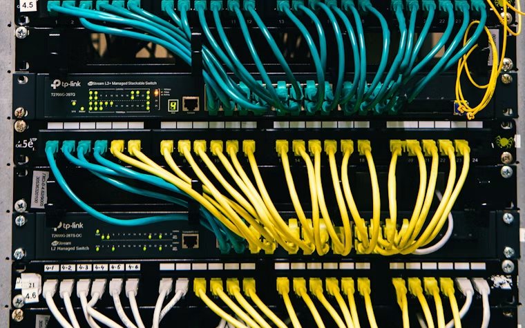 Network rack with organized patch cabling in a site communications room