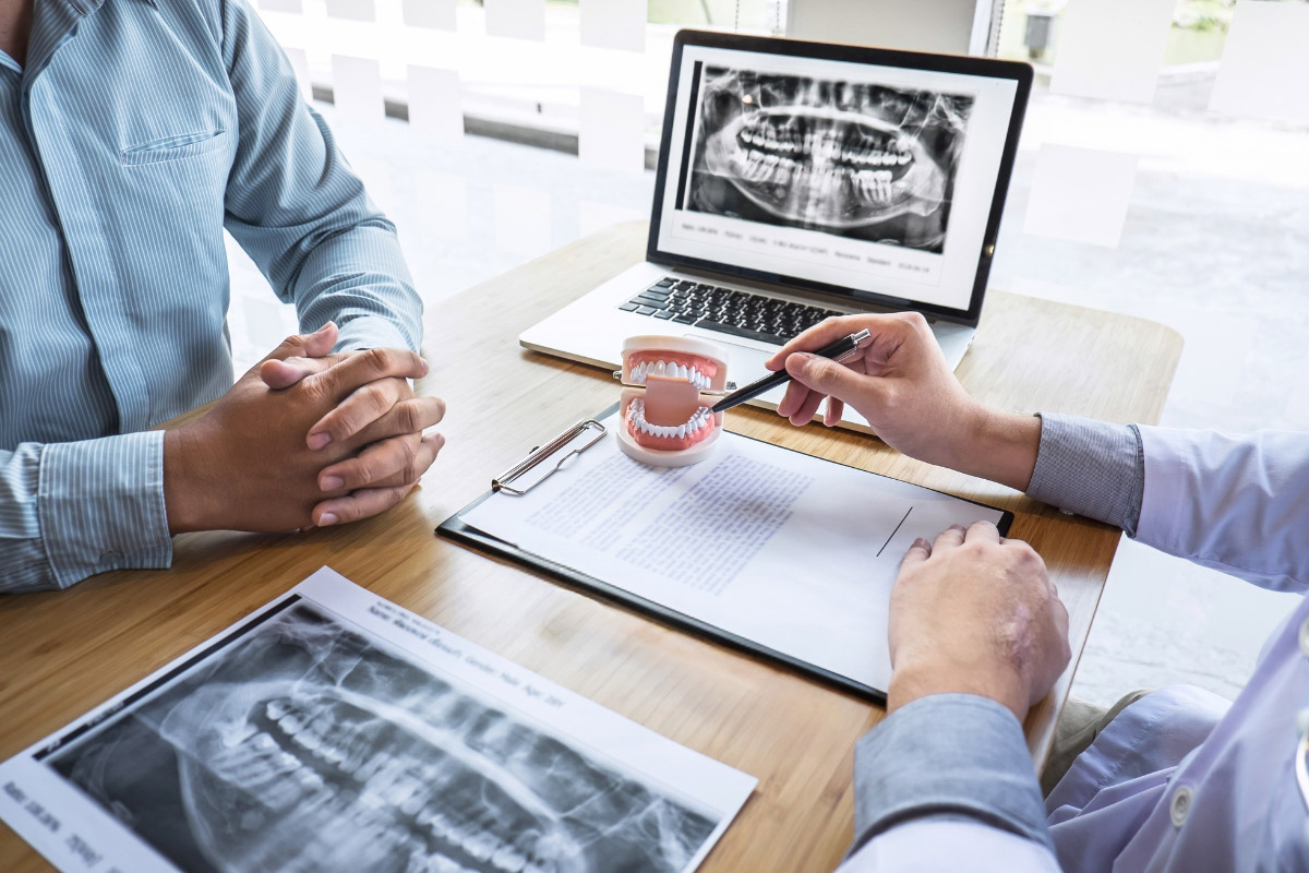 dentist discusses treatment plan with patient