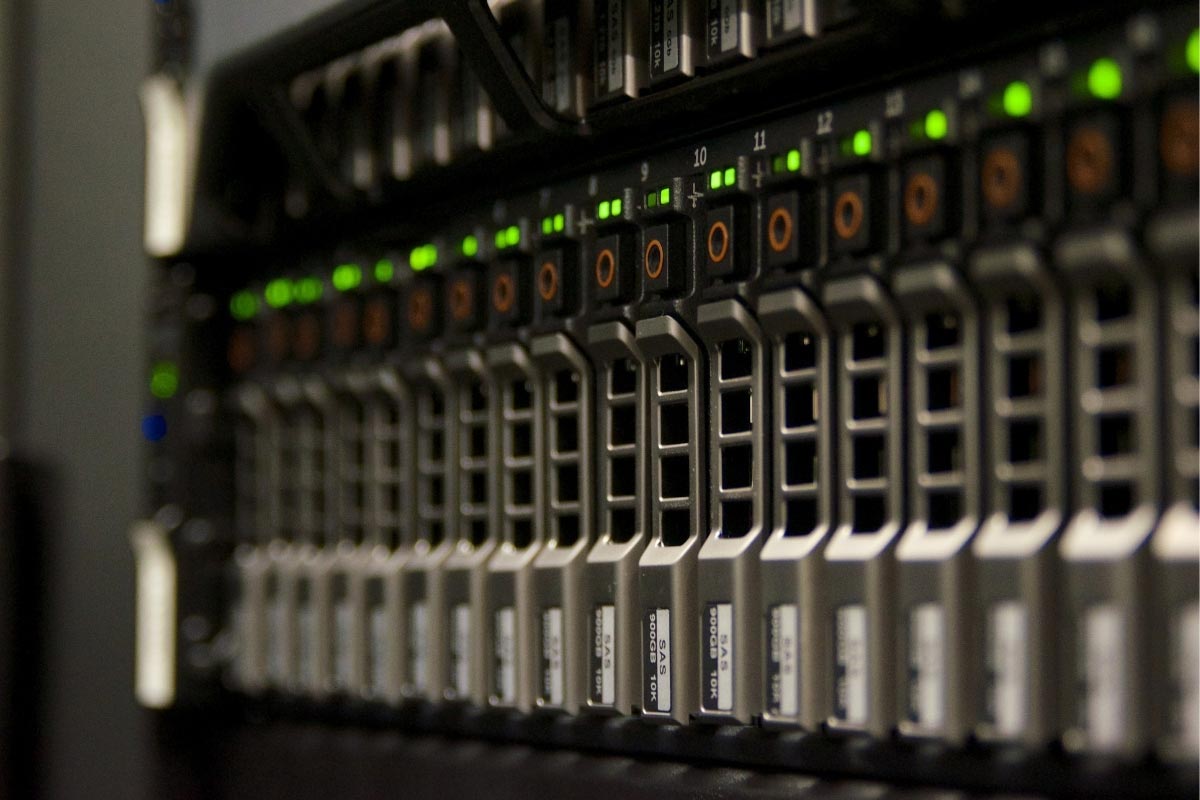 Close-up of high-end server rack hardware with green LED status lights, illustrating secure and compliant IT infrastructure for multi-location groups.